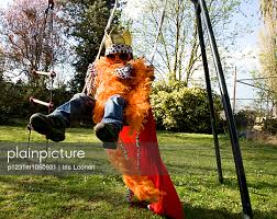 plainpicture - plainpicture p1231m1050931 - Boy on a swing dressed ...