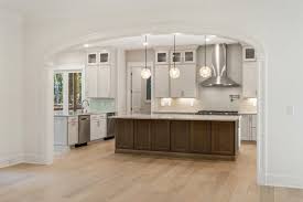 Example of a classic open concept living room design in seattle with a music area separation of kitchen from living via arches and only vaulting the living area, comfy chairs, recessed. Interior Arch Opening Gallery Curvemakers Arch Kits