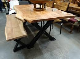 This contemporary table leg design is simply rustic. Wooden Dining Table Features A Black Metal X Base