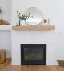 Gorgeous white paint and farmhouse decor make this brick fireplace pop! White Brick Fireplace Makeover Before After Misty Kingma White Brick Fireplace White Brick Fireplace Decor Fireplace Mantle Decor