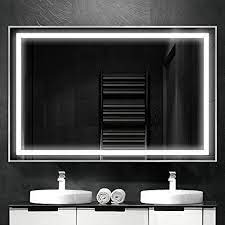 A rectangular tilted mirror has a frame, lamps along 3 edges, touch buttons: Citymoda 28x20inch Bathroom Mirror With Lights Large Dimmable Led Makeup Vanity Brushed Aluminum Frame Lighted Mirror With Touch Button Horizontal Vertical Anti Fog Color Adjustable Amazon Ca Home