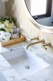 Don't see what you need? Antique Brass Spigot Faucet Mounted On White And Gold Wallpaper Transitional Bathroom