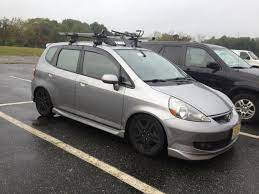You can find bike holders on this page: Roof Rack For The 2015 Fit Unofficial Honda Fit Forums