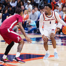 Alabama vs Auburn basketball game 2026 at Legacy Arena in Birmingham with players contesting a jump ball