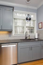 Stainless Steel Sink With Dark Gray Granite Countertops And Gray Shaker Cabinets Shaker Style Kitchen Cabinets Kitchen Cabinet Styles Kitchen Remodel Trends