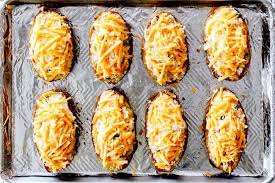 Showing How To Make Twice Baked Potatoes By Lining Potato Halves On A Baking Sheet And Best Twice Baked Potatoes Twice Baked Potatoes Easy Twice Baked Potatoes