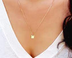 The karatage of the jewelry will tell you what percentage of gold it contains: Amazon Com Tiny Initial Necklace Gold Square Tag Necklace Personalized Small Letter Necklace Silver Or Rose Gold Monogram Square Shaped Necklace Handmade Products