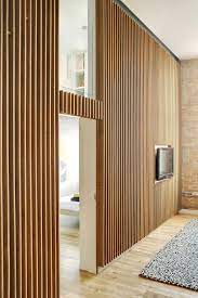 Vertical wood panel accent wall. Apartment At Bow Quarter Studio Verve Architects Wood Slat Wall Timber Walls Interior