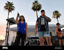 2nd Lt. Kristin Rowe, 56th Equipment Maintenance Squadron section commander  and Master Sgt. Mark Eyman, 944th Civil Engineer Squadron electrical  systems supervisor, sing a song together July 1, 2021, during the  FreedomFest