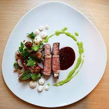 When plating, pick up the ready steak from the grill with tongs and set it on the plate without scooting it around, to avoid smears. Dry Aged Rib Eye Brown Butter Veggies Romanesco Jerusalem Artichoke Puree Parsley Green Garlic Vinaigret Food Plating Food Presentation Food Plating Techniques
