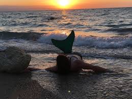 The mermaid protects the people of the island when they go into the water, and takes on the form of a woman on land. Mermaid At Sunset In Haiti Mermaiding