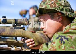 A U.S. Marine with 9th Communication (9th Comm) Battalion, I Marine  Expeditionary Force Information Group, fires a Mark 19 40mm grenade machine  gun during a live-fire range at Marine Corps Base Camp