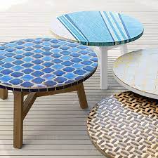 Has a metal base with round plastic feet. Elegantly Ornate Outdoor Furnishings Mosaic Tiled Coffee Table