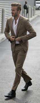 David Beckham With A Business Casual Combo With A Tan Suit White Button Up Shirt Brown Leather Belt David Beckham Style Outfits David Beckham Style Stylish Men