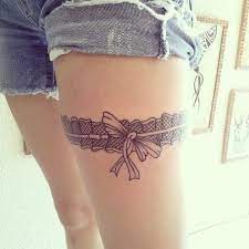 Short nice small pistol gun in belt tattoo. 100 Awesome Garter Tattoos Ultimate Guide August 2021