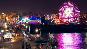 Take a walk around the santa monica pier and pacific park at night. Shutterstock