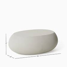 We added our smooth pebble coffee table for modern flair. Pebble Outdoor Coffee Table