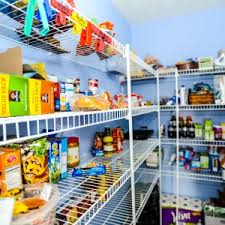 A wide shot of a pantry full with grocery items and white baskets. 7 Tips To Maximize Your Kitchen S Organization Angi Angie S List