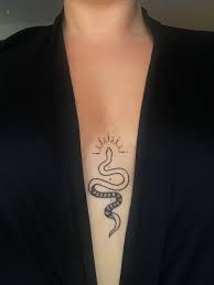 Minimal Sternum Snake Tattoo Black And White Black Minimal Snake Snaketattoo St In 2020 Foot Tattoos Minimalist Tattoo Snake Tattoo