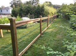Cedar Fence With Pressure Treated Posts And 3 Ft Welded Wire Sandwiched Between 1x4s Along The Top Landscaping Along Fence Backyard Fences Backyard Landscaping
