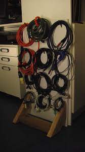25 Diy Cord And Cable Organizers For A Clean And Uncluttered Home Cable Organizer Room Diy Cord Storage