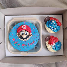 A box of customized combo Super Mario Themed Bento cake with 2 cupcakes For  orders or inquiries, kindly send us a direct message. #keikeuoven  #bentocake #monthsary #anniversary #manilafoodie #cookiesph #chocolatelover  #yummyph #manilacakes #