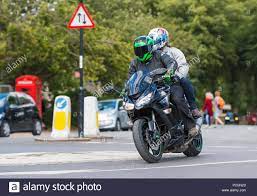 Person With Pillion Passenger Riding On A Kawasaki Z1000sx Motorbike In West Sussex England Uk Stock Photo Alamy