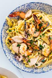 A creamy garlic prawn pasta with a garlic infused silky creamy sauce and plump prawns. Creamy Garlic Seafood Pasta Simply Delicious