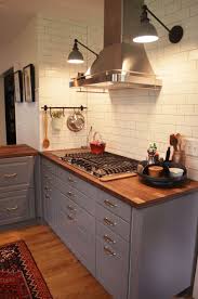 Schoolhouse Electric Sconces Over Gas Range Matte White Subway Tile Lighted Spice Drawers Under Range Renovation Maison Maison Cuisine