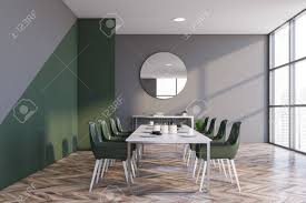 Perfect symbolisation is pictures of birds framed on the wall. Interior Of Modern Dining Room With Gray And Green Walls Wooden Floor Long White Table With Green Chairs And Cabinet With Round Mirror Above It 3d Rendering Stock Photo Picture And Royalty