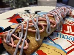 Want to discover art related to cheshirecat? Making The Cheshire Cat Tail Snack At Cheshire Cafe In Disney S Magic Kingdom Supercalifragilistic Awesome Disney Podcast
