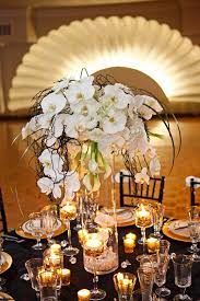Fabulous Floating Candle Ideas For Weddings In addition to the tall floral centerpieces, the reception tables were decorated with hurricane vases filled with ivory floating candles. fabulous floating candle ideas for weddings