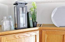 Add a few other similar arrangements on the counter and dining table to tie it all together. 12 Ways To Decorate Above Kitchen Cabinets Tag Tibby Design