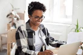 Check spelling or type a new query. Smiling Black Woman Sit At Desk Working At Laptop Review Paperwork Stock Photo Picture And Royalty Free Image Image 114277484