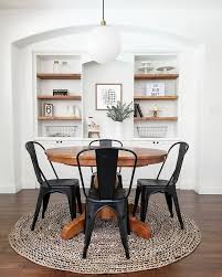 Neutral Farmhouse Dining Room Black Bistro Chairs Wood Pedestal Table Built In Shelves Minimalist White Dining Room Simple Dining Table Dining Room Design