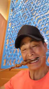 eating lamb skewers again. Xinjiang is known for their lamb skewers.