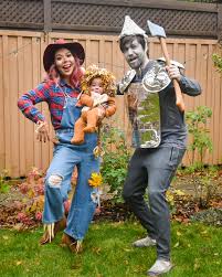 The dorothy costume was made with 1 1/2 yards of blue, checkered, flannel fabric, buttons, shoes, and glitter. Wizard Of Oz Family Halloween Costumes Eclectic Spark