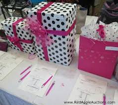 During a typical silent auction event, items for auction are displayed for participants to inspect closely. New Idea For Your Silent Auction Or Raffle Surprise Box Fundraising Gala Auctioneer Sherry Truhlar
