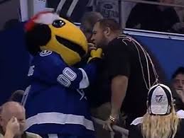 Coleman's smiling wife and baby daughter stand with the lightning's team mascot, a yellow lightning bug costumed character. Tampa Bay Lightning Mascot Fired After Altercation With Bruins Fan Cbs Boston