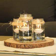 We Re Mad For Mason Jar Centerpieces Floating Candles Mason Jars Mason Jar Centerpieces Jar Centerpieces