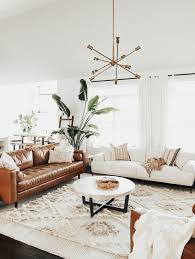 Along with the rug, the baskets full of hanging greenery add more colour and a touch of nature to the room. How To Create A Modern Boho Living Room Of Houses And Trees