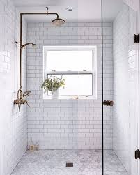 This Subway Tile Shower With A Window And Gold Accents Bathroom Remodel Shower Shower Remodel Bathrooms Remodel