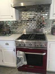 This may be one of the most traditional mirrored backsplashes you'll find, but that doesn't make it any less beautiful. Kitchen Backsplash Tile Antique Mirror Bevel Amalfi Glass Wall Tile Kitchen Design Diy Mirror Backsplash Kitchen Diy Kitchen Countertops