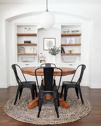 Neutral Farmhouse Dining Room Black Bistro Chairs Wood Pedestal Table Built In Shelves Minimalist White Dining Room Simple Dining Table Dining Room Design