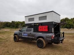 Pop up truck campers have been gaining popularity among campers thanks to their many benefits. Four Wheel Campers Reveals Lightweight Pop Top Truck Camper Gear Junkie Four Wheel Campers