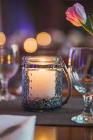 Dusty Blue Lanterns And Pillar Candles Add A Nice Soft Light To Any Wedding Dinner Table Candles Candle Light Wedding Pillar Candles