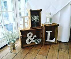 Wood Crates Used For A Simple Rustic Wedding Decoration With The Bride And Grooms Initials Fairy Lig Rustic Wedding Decor Wooden Crates Wedding Wedding Crates