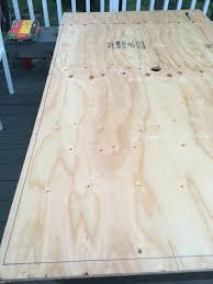 I then clamped the plywood to my work table with the first edge i wanted to trim hanging over the side, and used the jigsaw to cut down the line i'd marked. Diy Tile Tabletop Seeking Lavender Lane