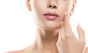 woman using RF face treatment device at home