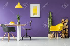 Product title novogratz teresa memory foam accent chair, living room furniture, mustard yellow velvet average rating: Dining Table Black Chairs Yellow Poster Plants And Firewood Log Rack In A Modern Dining Room Interior Stock Photo Picture And Royalty Free Image Image 103039831